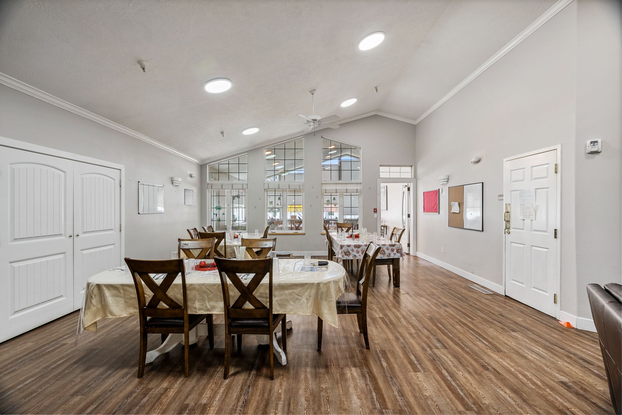 Bright common room with stone fireplace and dining tables