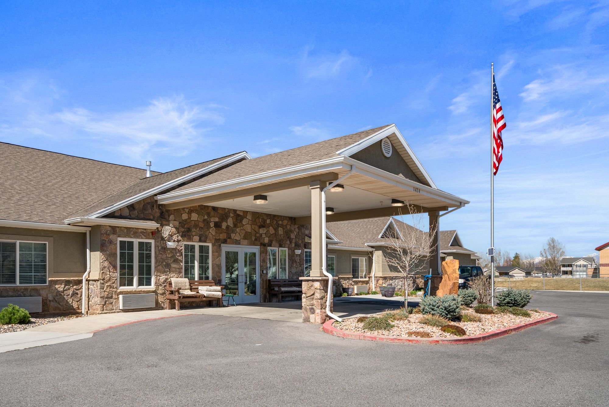 Covered front entrance of Hearthstone Manor with stone columns