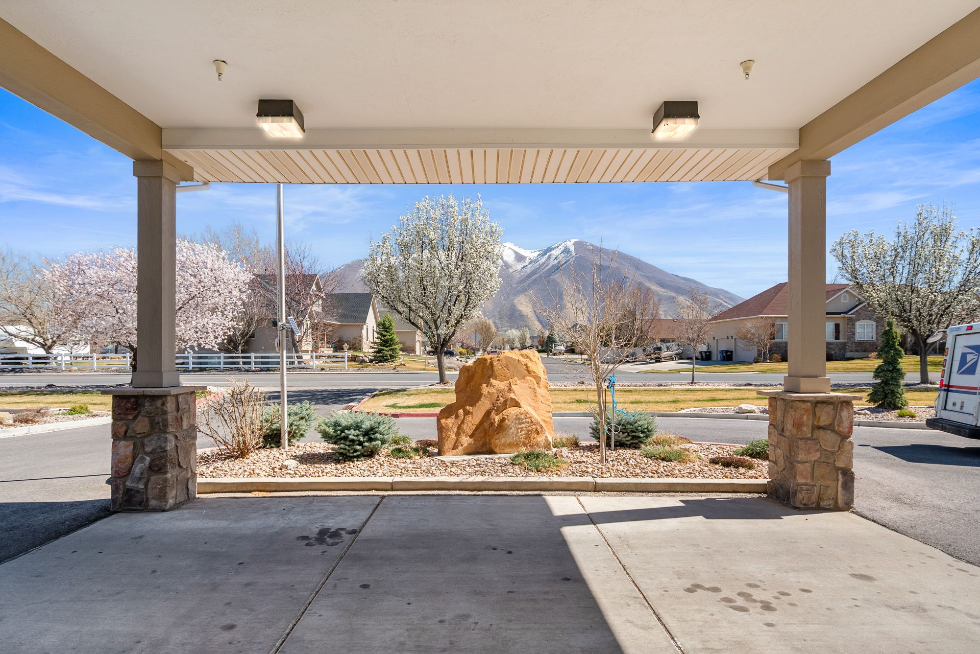 View of snow-capped Utah mountains framed by the Hearthstone Manor covered porch