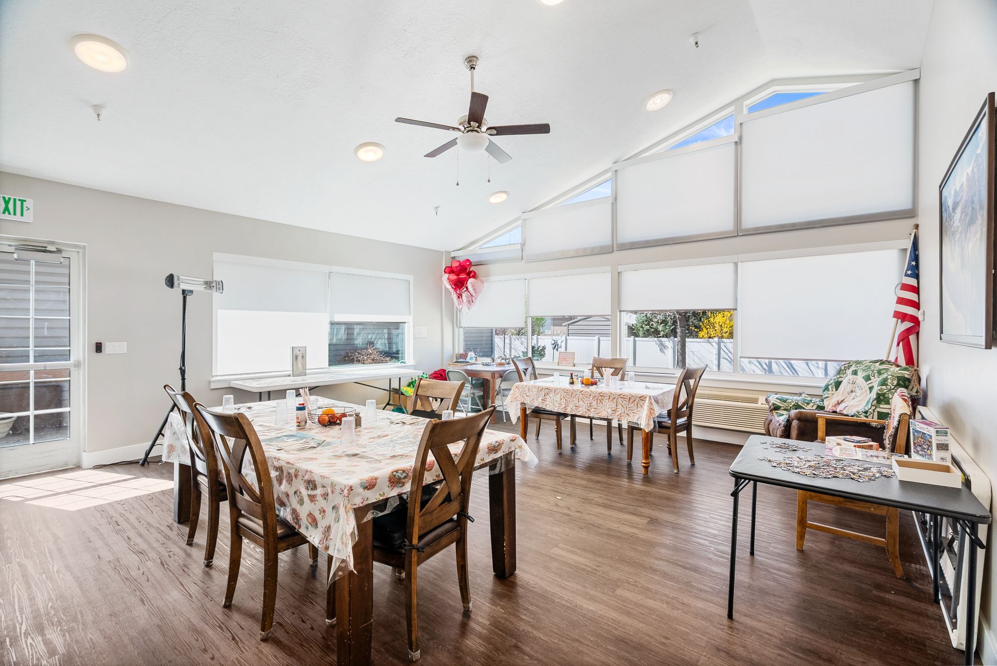 Bright sun room dining area with vaulted ceiling